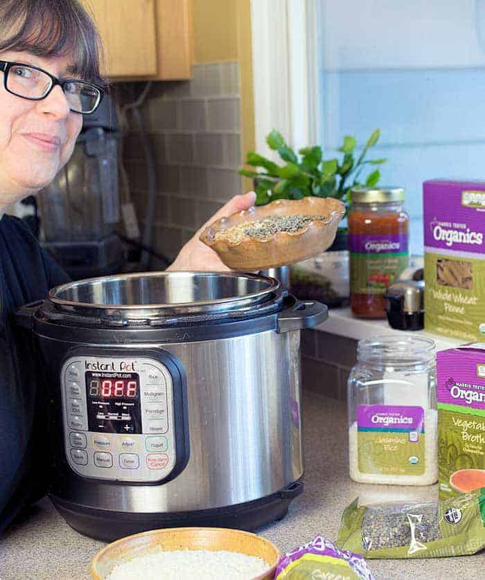 Kathy Hester pouring lentils into a 6-quart Duo Instant Pot