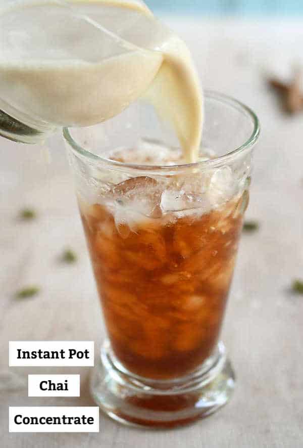 Nondairy milk being poured into a glass of iced chai