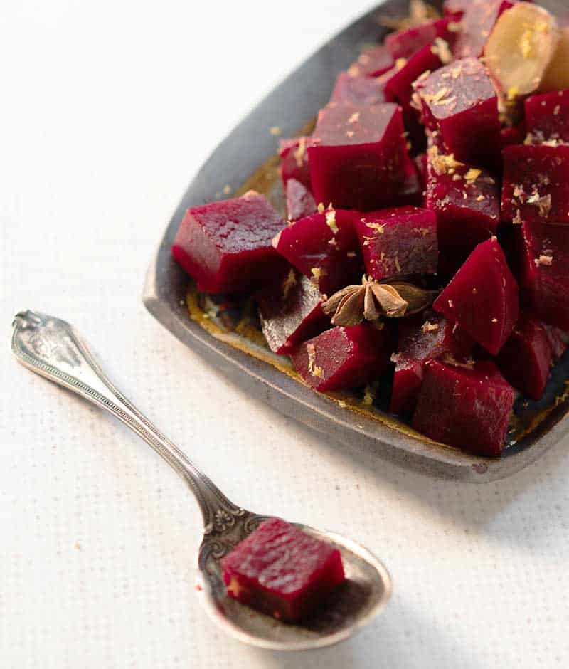 Instant Pot Asian Pickled Beets on a pottery plate with an antique silver spoon.