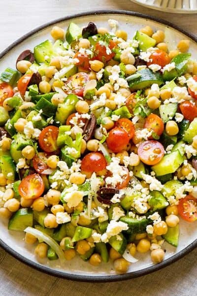 Instant Pot Vegan Chickpea Greek Salad in a beige bowl with a brown rim