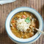 Instant Pot Oil-Free Mushroom Gumbo in a red wing pottery bowl topped with brown rice