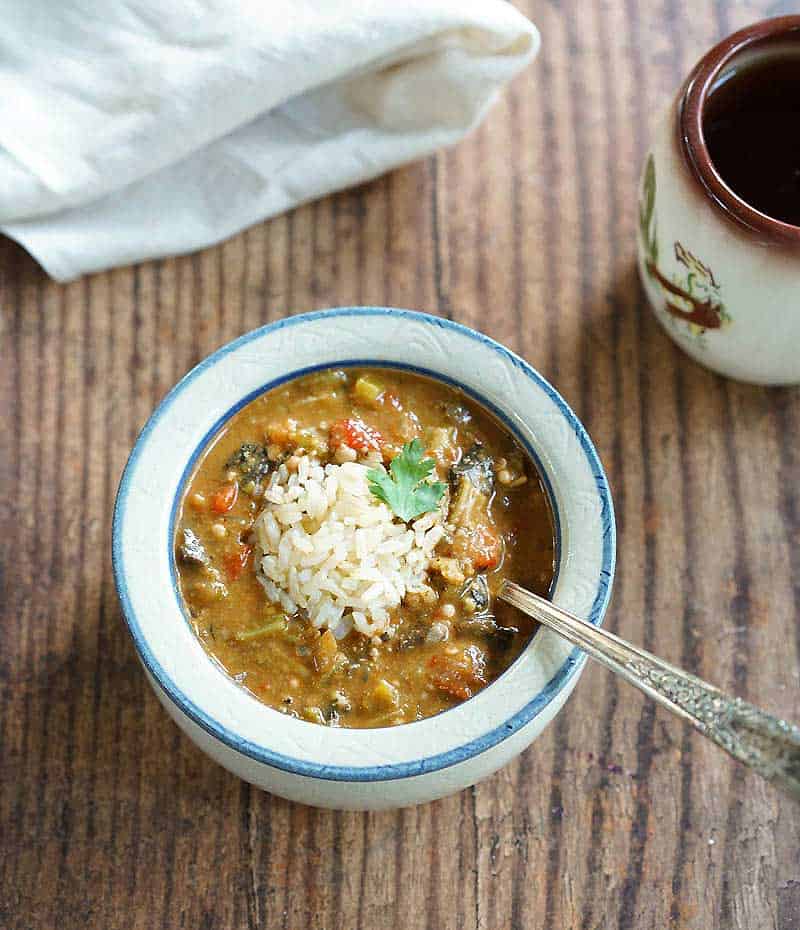 Instant Pot Oil-Free Mushroom Gumbo in a red wing pottery bowl topped with brown rice