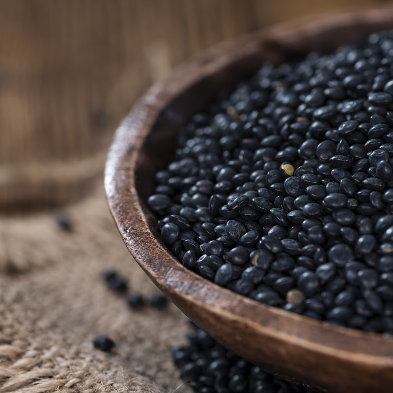 Black beluga lentils in a wooden bowl