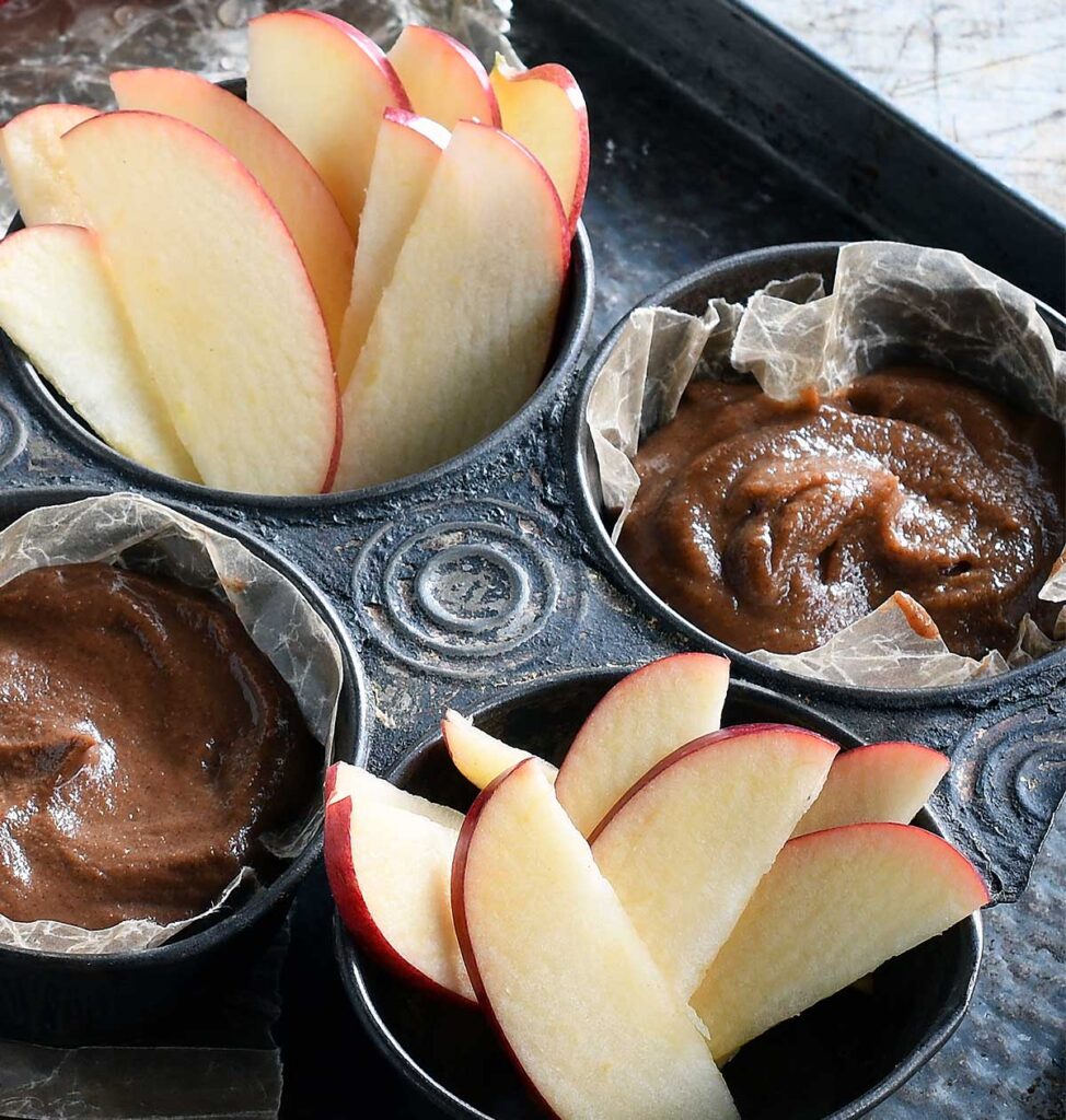 Date caramel hummus in an old muffin tin with sliced apples.